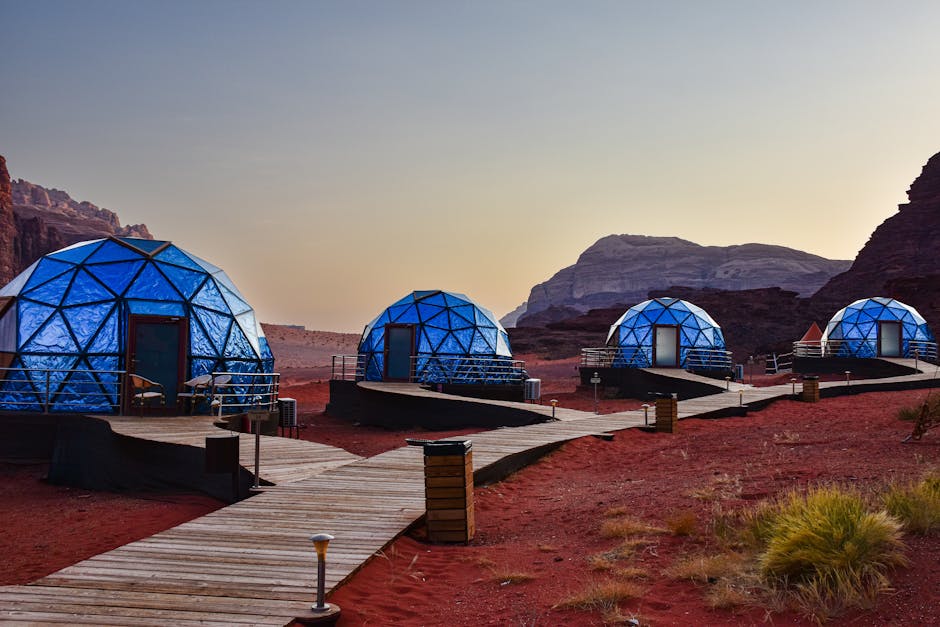 Luxurious geodesic dome tents in the scenic Wadi Rum desert landscape.